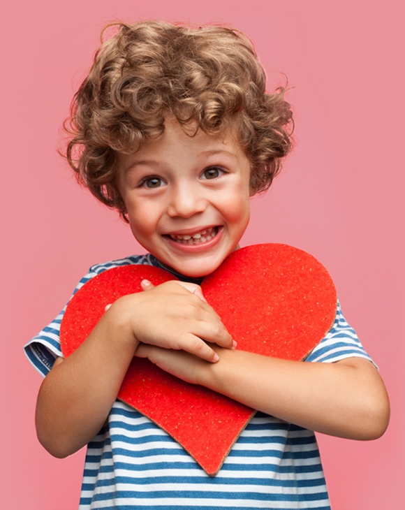 early treatment for a boy holding a big heart
