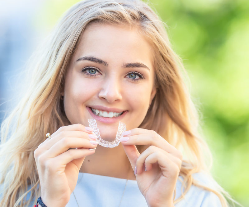 Young Attractive Woman Holding braces