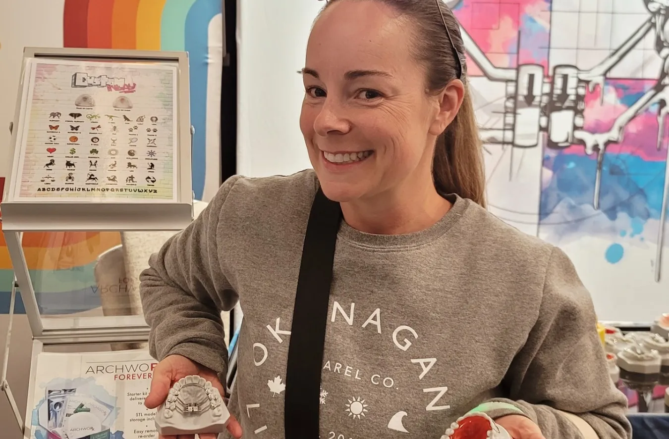 Models of orthodontic treatment options are displayed by a certified dental assistant.