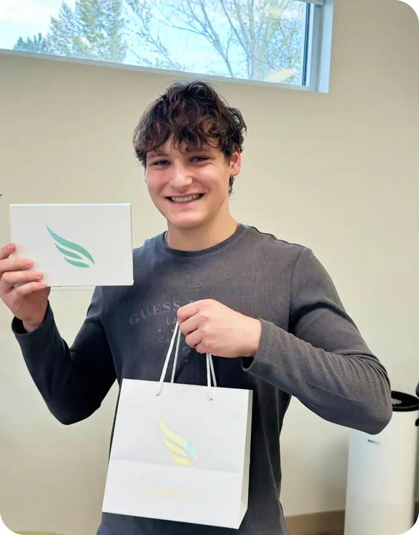 Smiling teen holding a Straight Smiles gift bag